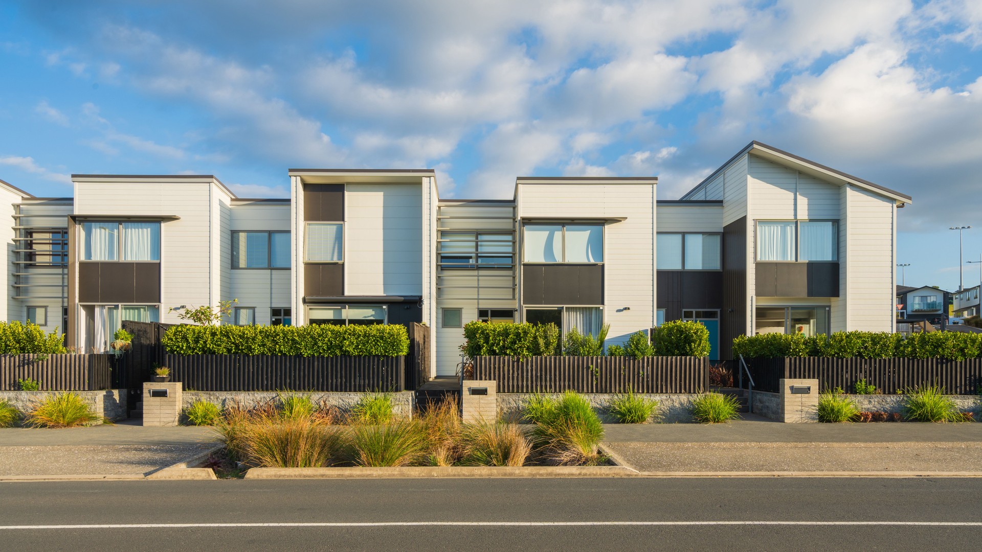 Residential townhouses on blue sky background.
